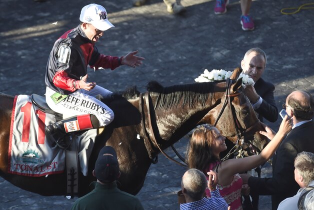 Jockey Joel Rosario celebrates atop Tonalist after winning the Belmont Stakes horse race, Saturday, June 7, 2014, in Elmont, N.Y. (AP Photo/Bill Kostroun)