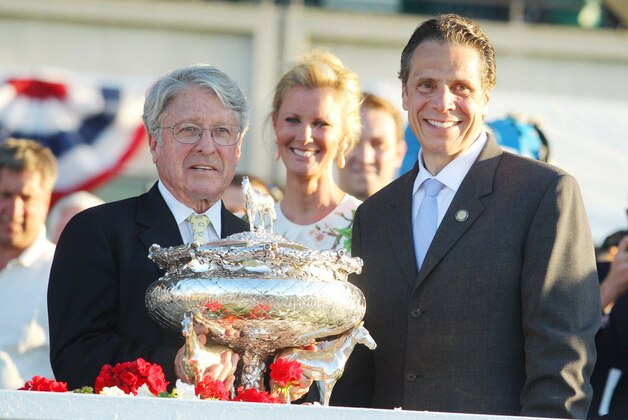 Jun 7, 2014; Elmont, NY, USA; Tonalist owner Robert S. Evans (left) is presented the Belmont Stakes trophy by New York governor Andrew Cuomo (right) during the 2014 Belmont Stakes at Belmont Park. Mandatory Credit: Brad Penner-USA TODAY Sports