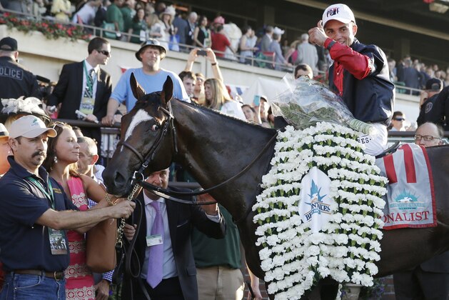 Joel Rosario poses for photos atop Tonalist after winning the 146th running of the Belmont Stakes horse race, Saturday, June 7, 2014, in Elmont, N.Y. (AP Photo/Seth Wenig)