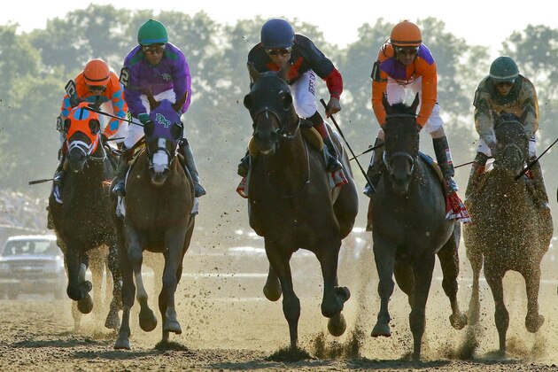 Tonalist, center, with Joel Rosario up, approaches the finish line to win the Belmont Stakes horse race, Saturday, June 7, 2014, in Elmont, N.Y. Other horses are, from left, General a Rod (10), California Chrome (2), Medal Count (1), and Samraat. (AP Photo/Matt Slocum)