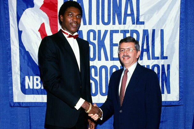 1984: NBA commissioner David Stern congratulates Akeem Olajuwon after being drafted first overall by the Houston Rockets during the 1984 NBA Draft. NOTE TO USER: User expressly acknowledges and agrees that, by downloading and or using this photograph, User is consenting to the terms and conditions of the Getty Images License Agreement. Mandatory copyright notice: Copyright NBAE 2002 (Photo by Noren Trotman/NBAE/Getty Images)