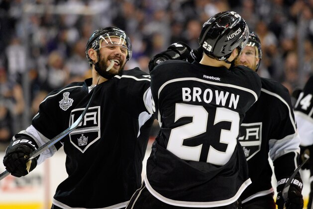 LOS ANGELES, CA - JUNE 07:  Dustin Brown #23 of the Los Angeles Kings celebrates with Alec Martinez #27 after Brown scored double overtime game winner as the Kings defeat the New York Rangers 5-4 during Game Two of the 2014 NHL Stanley Cup Final at the Staples Center on June 7, 2014 in Los Angeles, California.  (Photo by Harry How/Getty Images)