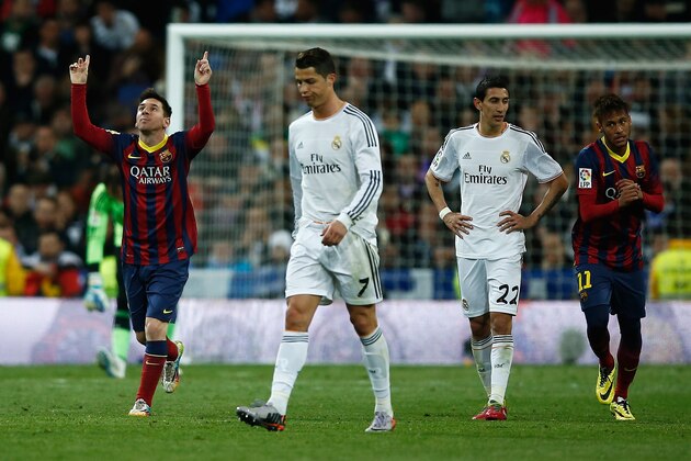 MADRID, SPAIN - MARCH 23:  Lionel Messi (L) of Barcelona celebrates scoring his team's third goal with Neymar (R) of Barcelona as Cristiano Ronaldo and Angel Di Maria of Real Madrid look dejected during the La Liga match between Real Madrid CF and FC Barcelona at the Bernabeu on March 23, 2014 in Madrid, Spain.  (Photo by Gonzalo Arroyo Moreno/Getty Images)