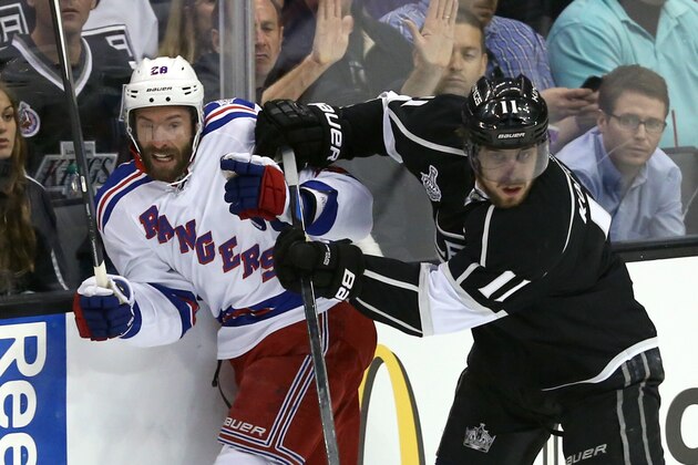 LOS ANGELES, CA - JUNE 07:  Dominic Moore #28 of the New York Rangers is checked by Anze Kopitar #11 of the Los Angeles Kings during Game Two of the 2014 NHL Stanley Cup Final at the Staples Center on June 7, 2014 in Los Angeles, California.  (Photo by Victor Decolongon/Getty Images)