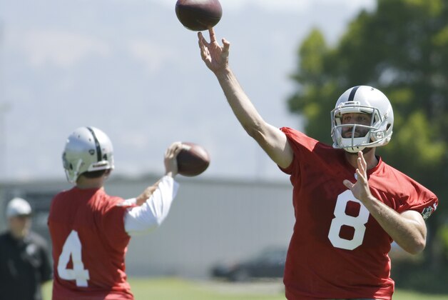 Oakland Raiders quarterbacks Matt Schaub (8) and Derek Carr, left, throw passes during an NFL football minicamp Tuesday, May 27, 2014, in Alameda, Calif. (AP Photo/Ben Margot)