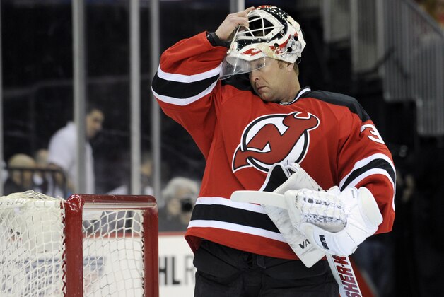 New Jersey Devils goaltender Martin Brodeur puts on his mask before playing against the Detroit Red Wings in an NHL hockey game Tuesday, March 4, 2014, in Newark, N.J. (AP Photo/Bill Kostroun)