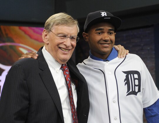 Baseball Commissioner Bud Selig, left, poses with outfielder Derek Hill from Elk Grove High School in Sacramento, California, at the 2014 MLB baseball draft Thursday, June 5, 2014, in Secaucus, N.J. Hill was selected by the Detroit Tigers with the 23rd pick in the first round. (AP Photo/Bill Kostroun)