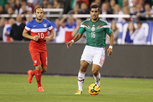 GLENDALE, AZ - APRIL 02:  Miguel Angel Ponce #16 of Mexico controls the ball ahead of Landon Donovan #10 of USA during the International Friendly at University of Phoenix Stadium on April 2, 2014 in Glendale, Arizona. Mexico and USA played to a 2-2 tie.  (Photo by Christian Petersen/Getty Images)