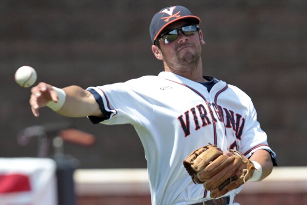 Virginia infielder Branden Cogswell throws to first base in the seventh inning of an NCAA college baseball tournament super regional game against Maryland in Charlottesville, Va., Saturday, June 7, 2014. Maryland defeated Virginia 5-4. (AP Photo/Andrew Shurtleff)
