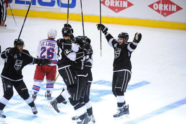 LOS ANGELES, CA - JUNE 7:  The Los Angeles Kings celebrate after scoring the game-winning goal against the New York Rangers in the second overtime period of Game Two of the Stanley Cup Final during the 2014 Stanley Cup Playoffs at Staples Center on June 7, 2014 in Los Angeles, California. (Photo by Jon Soohoo/NHLI via Getty Images)