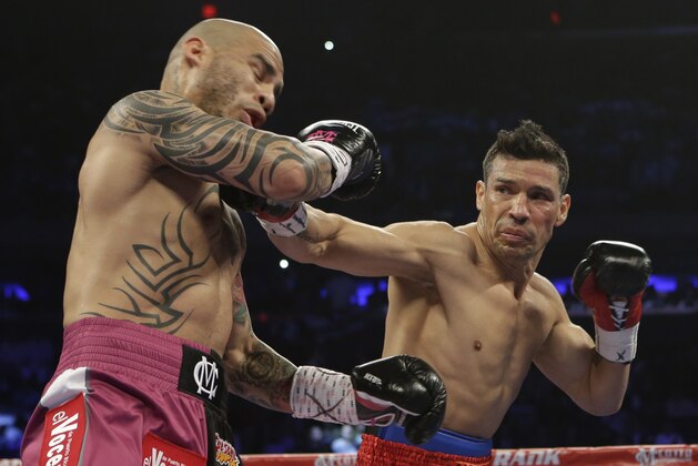 Sergio Martinez, of Argentina, punches Miguel Cotto, of Puerto Rico, during the first round of a WBC World Middleweight Title boxing match Saturday, June 7, 2014, in New York.  (AP Photo/Frank Franklin II)