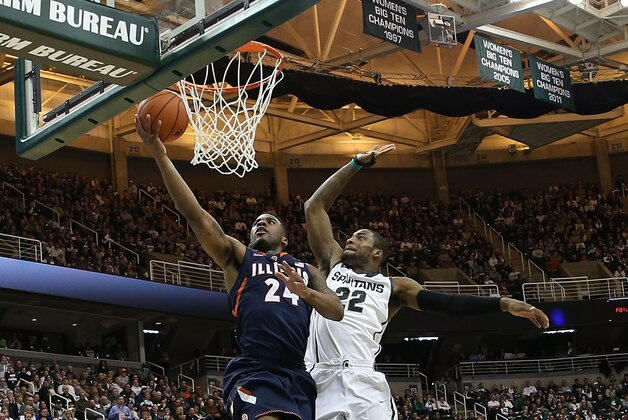EAST LANSING, MI - MARCH 01:  Rayvonte Rice #24 of the University of Illinois drives the ball to the basket as Branden Dawson #22 of the Michigan State Spartans attempts to defend during the first half of the game at the Breslin Center on March 1, 2014 in East Lansing, Michigan.  (Photo by Leon Halip/Getty Images)