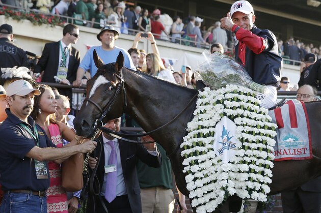 Joel Rosario poses for photos atop Tonalist after winning the 146th running of the Belmont Stakes horse race, Saturday, June 7, 2014, in Elmont, N.Y. (AP Photo/Seth Wenig)