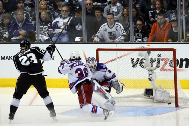 LOS ANGELES, CA - JUNE 07:  Dustin Brown #23 of the Los Angeles Kings takes a shot against goaltender Henrik Lundqvist #30 of the New York Rangers in double overtime during Game Two of the 2014 NHL Stanley Cup Final at the Staples Center on June 7, 2014 in Los Angeles, California.  (Photo by Victor Decolongon/Getty Images)
