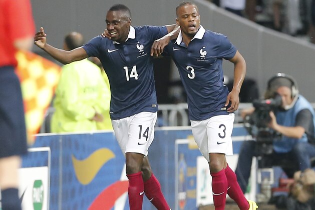 French soccer Blaise Matuidxi, left,reacts after scoring against Jamaica with Patrice Evra during the friendly soccer match between France and Jamaica at the Lille Metropole stadium, in Villeneuve d'Ascq, northern France, Sunday, June 8, 2014.  France in preparation for the upcoming FIFA soccer World Cup in Brazil starting on 12 June. (AP Photo/Jacques Brinon)