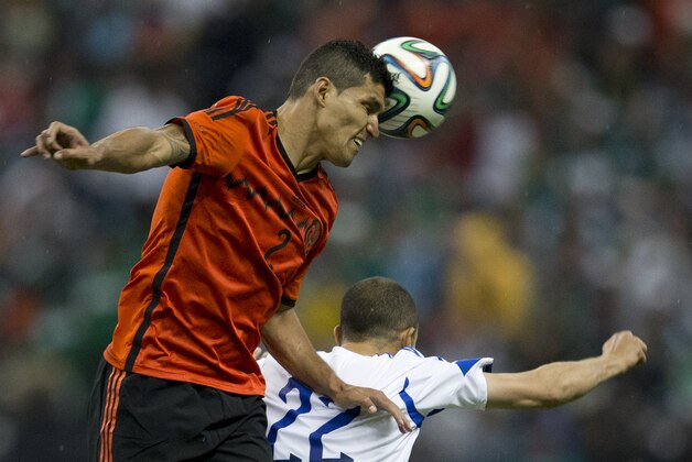 Mexico's Francisco Rodriguez heads the ball as he battles with Israel's Omer Damari at a friendly soccer match in Mexico City, Wednesday, May 28, 2014. (AP Photo/Eduardo Verdugo)