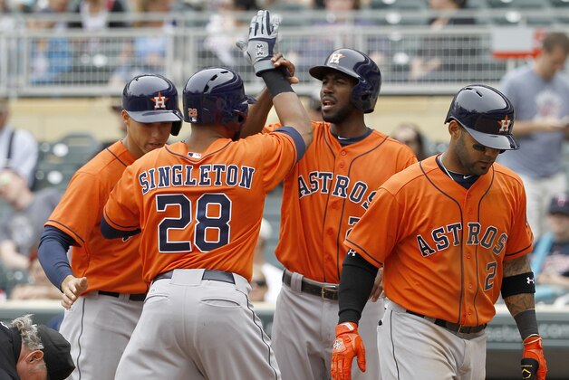 Houston Astros'  Jon Singleton (28) is congratulated by teammates George Springer, left, Dexter Fowler and Jonathan Villar, right, after Singleton's grand slam off Minnesota Twins relief pitcher Glen Perkins during the ninth inning of a baseball game in Minneapolis, Sunday, June 8, 2014. The Astros won 14-5. (AP Photo/Ann Heisenfelt)