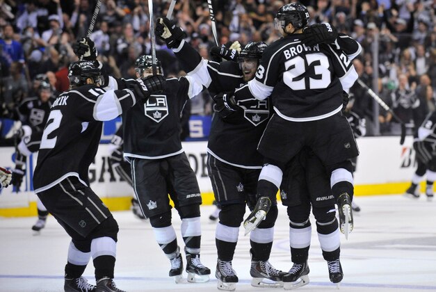Jun 7, 2014; Los Angeles, CA, USA; Los Angeles Kings right wing Dustin Brown (23) celebrates with his teammates after scoring the game-winning goal against the New York Rangers in the second overtime period during game two of the 2014 Stanley Cup Final at Staples Center. Mandatory Credit: Gary A. Vasquez-USA TODAY Sports