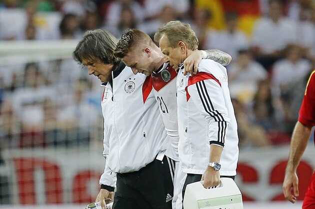 Germany's Marco Reus, center, leaves the pitch after he was injured during a soccer friendly match between Germany and Armenia in the Coface Arena in Mainz, Germany, Friday, June 6, 2014. (AP Photo/Michael Probst)