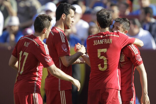Spain’s David Villa, right,  celebrates with teammates Koke (17) Sergio Busquets, and Juanfran Torres (5) after scoring his second goal of the game during the second half of an exhibition soccer game against El Salvador, Saturday, June 7, 2014, in Landover, Md. Spain won 2-0. (AP Photo/Luis M. Alvarez)