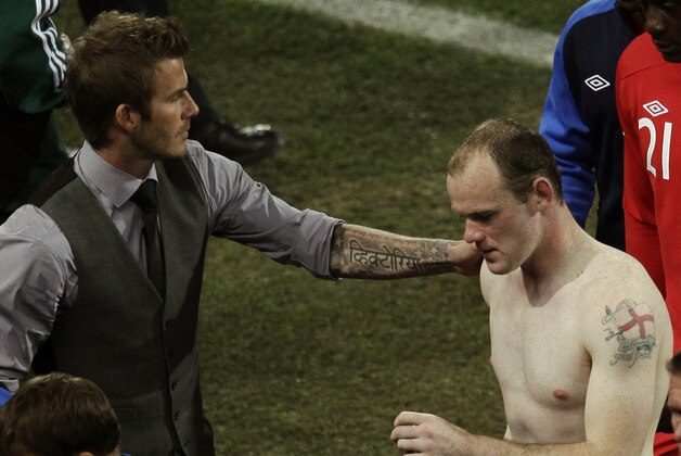 Former England captain David Beckham, left, greets England's Wayne Rooney, right, following the World Cup round of 16 soccer match between Germany and England at Free State Stadium in Bloemfontein, South Africa, Sunday, June 27, 2010. Germany defeated England 4-1, thereby advancing to the quarterfinals. (AP Photo/Michael Sohn)