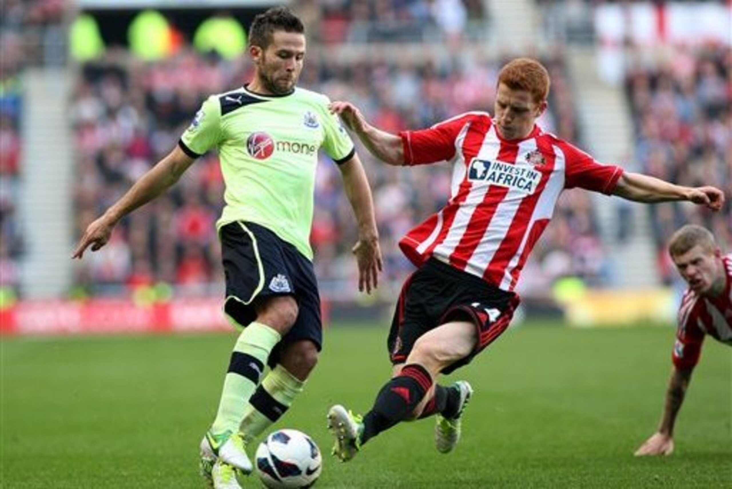 Newcastle United's Yohan Cabaye, left, vies for the ball with Sunderland's Jack Colback, right, during their English Premier League soccer match at the Stadium of Light, Sunderland, England, Sunday, Oct. 21, 2012. (AP Photo/Scott Heppell)