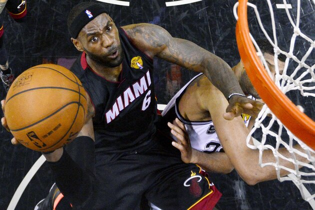 Miami Heat forward LeBron James shoots over San Antonio Spurs forward Tim Duncan (21) during the first half in Game 2 of the NBA basketball finals on Saturday, Nov. 8, 2014, in San Antonio. (AP Photo/Larry W. Smith, pool)
