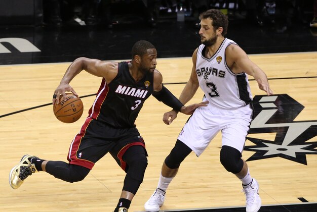 Jun 8, 2014; San Antonio, TX, USA; Miami Heat guard Dwyane Wade (3) drives against San Antonio Spurs guard Marco Belinelli (3) in game two of the 2014 NBA Finals at AT&T Center. Mandatory Credit: Soobum Im-USA TODAY Sports
