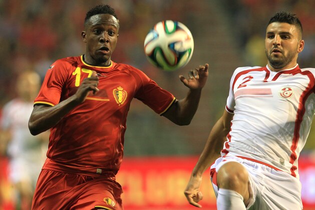 Tunisia's Syam Ben Youssef, right, is challenged by Belgium's Divock Origi during a friendly soccer match at the King Baudouin stadium in Brussels, Saturday, June 7, 2014.  Belgium will play against South Korea, Russia and Algeria in Group H of the World Cup 2014 in Brazil. (AP Photo/Yves Logghe)