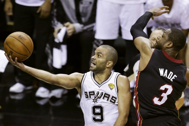 San Antonio Spurs guard Tony Parker (9) shoots against Miami Heat guard Dwyane Wade (3) during the first half in Game 2 of the NBA basketball finals on Sunday, June 8, 2014, in San Antonio. (AP Photo/Tony Gutierrez)