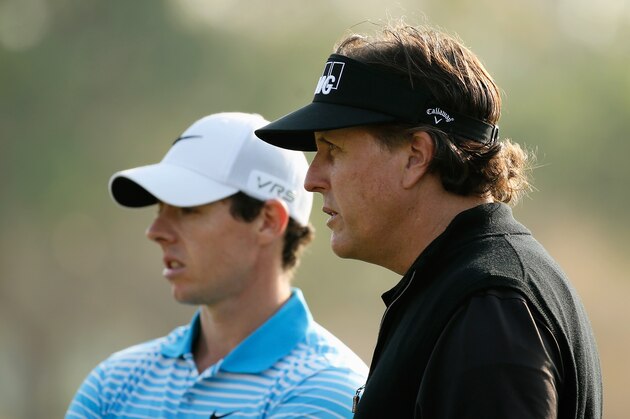 ABU DHABI, UNITED ARAB EMIRATES - JANUARY 16:  Rory McIlroy of Northern Ireland (L) waits on the 16th green with Phil Mickelson of the USA during the first round of the Abu Dhabi HSBC Golf Championship at the Abu Dhabi Golf Clubon January 16, 2014 in Abu Dhabi, United Arab Emirates.  (Photo by Scott Halleran/Getty Images)