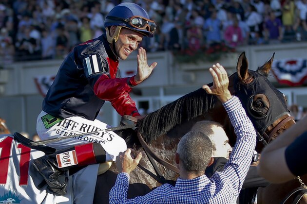 Joel Rosario, atop Tonalist, celebrates after they won the Belmont Stakes horse race, Saturday, June 7, 2014, in Elmont, N.Y. (AP Photo/Matt Slocum)
