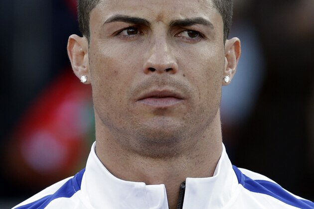 Portugal's Cristiano Ronaldo listens to the national anthems prior a friendly soccer match between Portugal and Greece at the National stadium, in Oeiras, near Lisbon, Saturday, May 31, 2014. The game was a warm-up match for both teams ahead the World Cup in Brazil. The match ended in a 0-0 draw. (AP Photo/Francisco Seco)