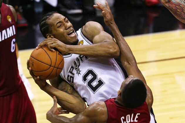 SAN ANTONIO, TX - JUNE 5: Kawhi Leonard #2 of the San Antonio Spurs is fouled while shooting by Norris Cole #30 of the Miami Heat in Game One of the 2014 NBA Finals at the AT&T Center on June 5, 2014 in San Antonio, Texas. NOTE TO USER: User expressly acknowledges and agrees that, by downloading and/or using this photograph, user is consenting to the terms and conditions of the Getty Images License Agreement. (Photo by Chris Covatta/Getty Images)