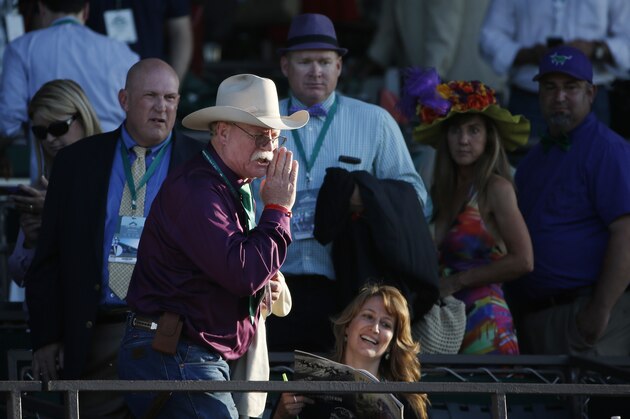 California Chrome co-owner Steve Coburn calls from the grandstand at Belmont Park after his horse finished fourth in the Belmont Stakes horse race, Saturday, June 7, 2014, in Elmont, N.Y. (AP Photo/Kathy Willens)