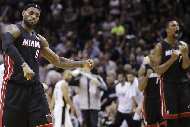 Miami Heat forward LeBron James (6) and center Chris Bosh (1) react against the San Antonio Spurs after Game 2 of the NBA basketball finals on Sunday, June 8, 2014, in San Antonio. Miami won 98-96. (AP Photo/Eric Gay)