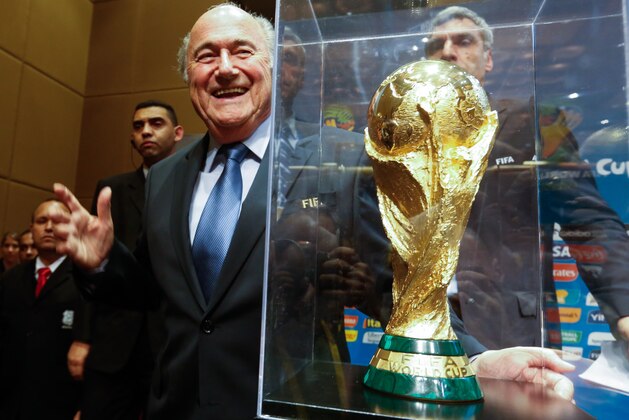 SAO PAULO, BRAZIL - JUNE 05: President of FIFA Joseph Blatter poses beside the copy of the trophy of the World Cup after the press conference following the last session of the Organising Committee for the FIFA World Cup at the Grand Hyatt Hotel on June 5, 2014 in Sao Paulo, Brazil. (Photo by Alexandre Schneider/Getty Images)