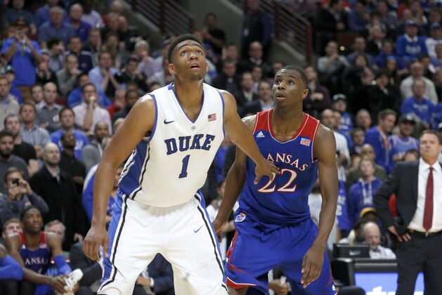 Duke forward Jabari Parker and Kansas guard Andrew Wiggins look for a possible rebound off a free-throw attempt during the second half of an NCAA college basketball game Tuesday, Nov. 12, 2013, in Chicago. Kansas won 94-83. (AP Photo/Charles Rex Arbogast)