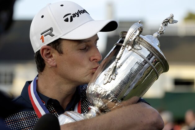 Justin Rose, of England, kisses the trophy after winning the U.S. Open golf tournament at Merion Golf Club, Sunday, June 16, 2013, in Ardmore, Pa. (AP Photo/Julio Cortez)