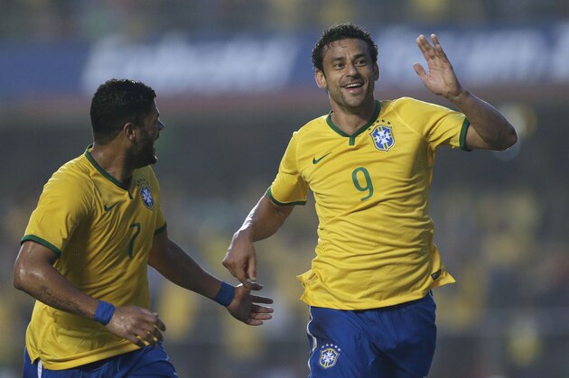 Brazil's Fred, right, celebrates with teammate Hulk after scoring against Serbia during a friendly soccer match at Morumbi stadium in Sao Paulo, Brazil, Friday, June 6, 2014. Brazil is hosting the World Cup soccer tournament that starts June 12. (AP Photo/Andre Penner)