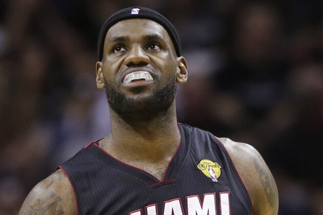 Miami Heat forward LeBron James pauses between plays against the San Antonio Spurs during the first half in Game 2 of the NBA basketball finals on Sunday, June 8, 2014, in San Antonio. (AP Photo/Eric Gay)