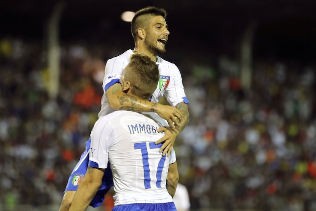 Italy's national soccer team player Lorenzo Insigne, top, celebrates with his teammate Ciro Immobile after scoring during a World Cup warm up soccer match between Italy and Fluminense at the Cidadania stadium, in Volta Redonda, Brazil, Sunday, June 8, 2014. Italy plays in group D of the 2014 soccer World Cup. (AP Photo/Antonio Calanni)
