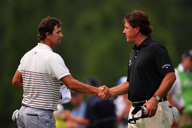 ROCHESTER, NY - AUGUST 08:  (L-R) Adam Scott of Australia and Phil Mickelson of the United States finish their round on the 18th hole during the first round of the 95th PGA Championship on August 8, 2013 in Rochester, New York.  (Photo by Stuart Franklin/Getty Images)
