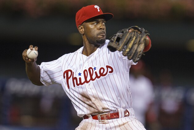 Philadelphia Phillies shortstop Jimmy Rollins looks to throw the ball during the sixth inning of a baseball game, Wednesday, Aug. 7, 2013, in Philadelphia. Chicago won 5-2. (AP Photo/Christopher Szagola)
