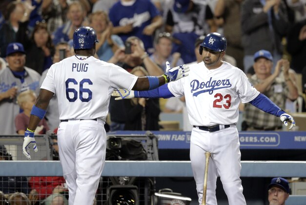 Los Angeles Dodgers' Yasiel Puig, left, celebrates his home run with Adrian Gonzalez during the sixth inning of a baseball game against the Cincinnati Reds on Wednesday, May 28, 2014, in Los Angeles. (AP Photo/Jae C. Hong)