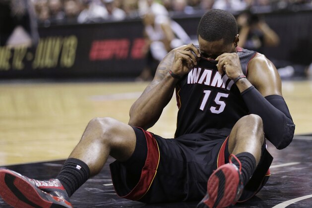 Miami Heat guard Mario Chalmers (15) recovers after hitting the floor against the San Antonio Spurs during the first half in Game 2 of the NBA basketball finals on Sunday, June 8, 2014, in San Antonio. (AP Photo/Eric Gay)