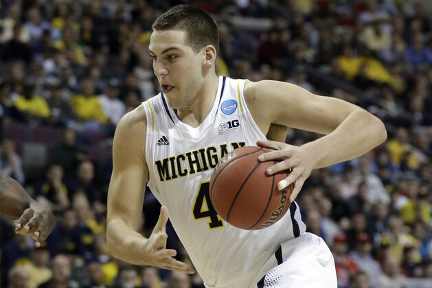 Michigan forward Mitch McGary (4) drives against Virginia Commonwealth in their third-round game of the NCAA college basketball tournament in Auburn Hills, Mich., Saturday March 23, 2013. (AP Photo/Paul Sancya)