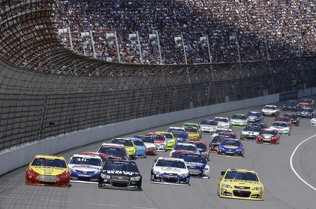 Cars race during the NASCAR Sprint Cup series Pure Michigan 400 auto race at Michigan International Speedway in Brooklyn, Mich., Sunday, Aug. 18, 2013. (AP Photo/Paul Sancya)