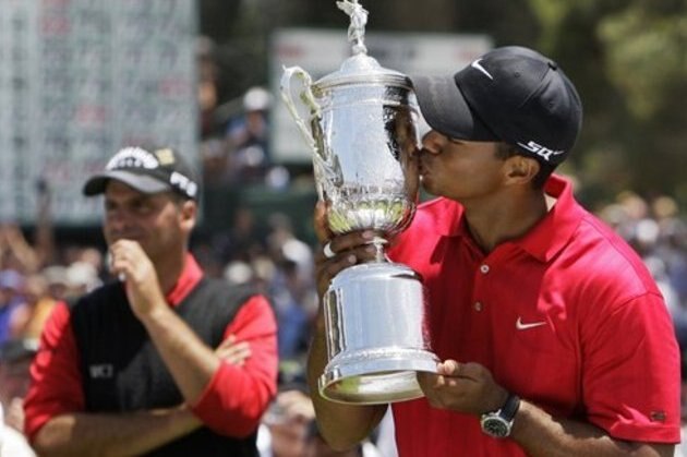 FILE - This is a June 16, 2008, file photo showing Tiger Woods kissing the championship trophy after winning the US Open,  against Rocco Mediate, left, after a sudden death hole following an 18-hole playoff round at Torrey Pines Golf Course,  in San Diego.