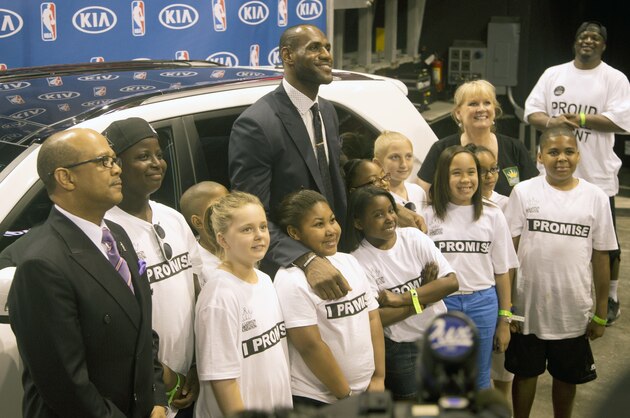 LeBron James was the overwhelming choice as the NBA's Most Valuable Player. The Miami Heat star took 120 of 121 first-place votes in this year's balloting, giving him the award for the fourth time. Oklahoma City's Kevin Durant finished second and the New York Knicks' Carmelo Anthony was third. He poses with a group of Akron, Ohio school kids, he invited to the ceremony. (AP Photo/J Pat Carter)